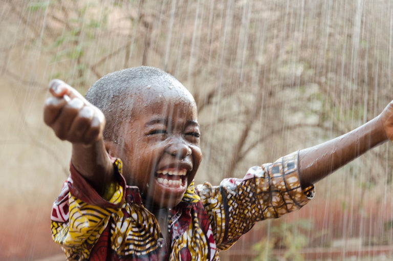 Child in the rain, by Riccardo Mayer, Shutterstock, Travel Africa magazine